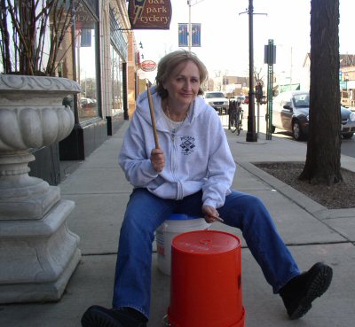 Audiologist Patricia McCarthy plays the bucket drum
